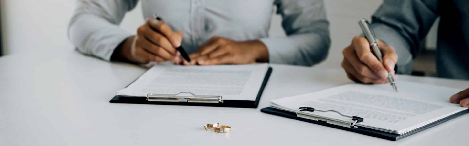 Husband and Wife Signing Divorce Documents