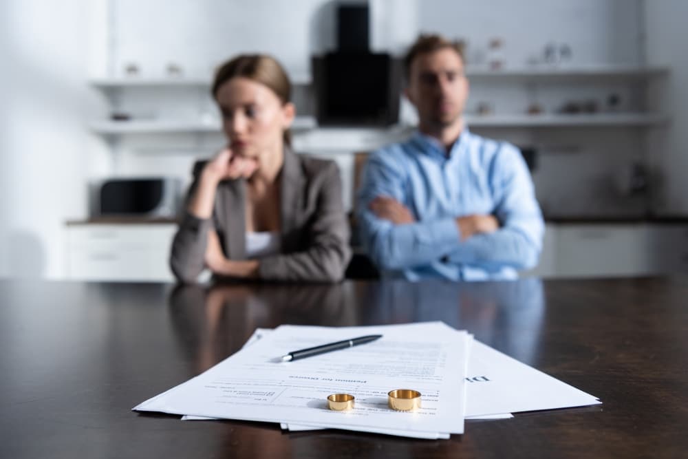 Couple sitting at table with divorce paper